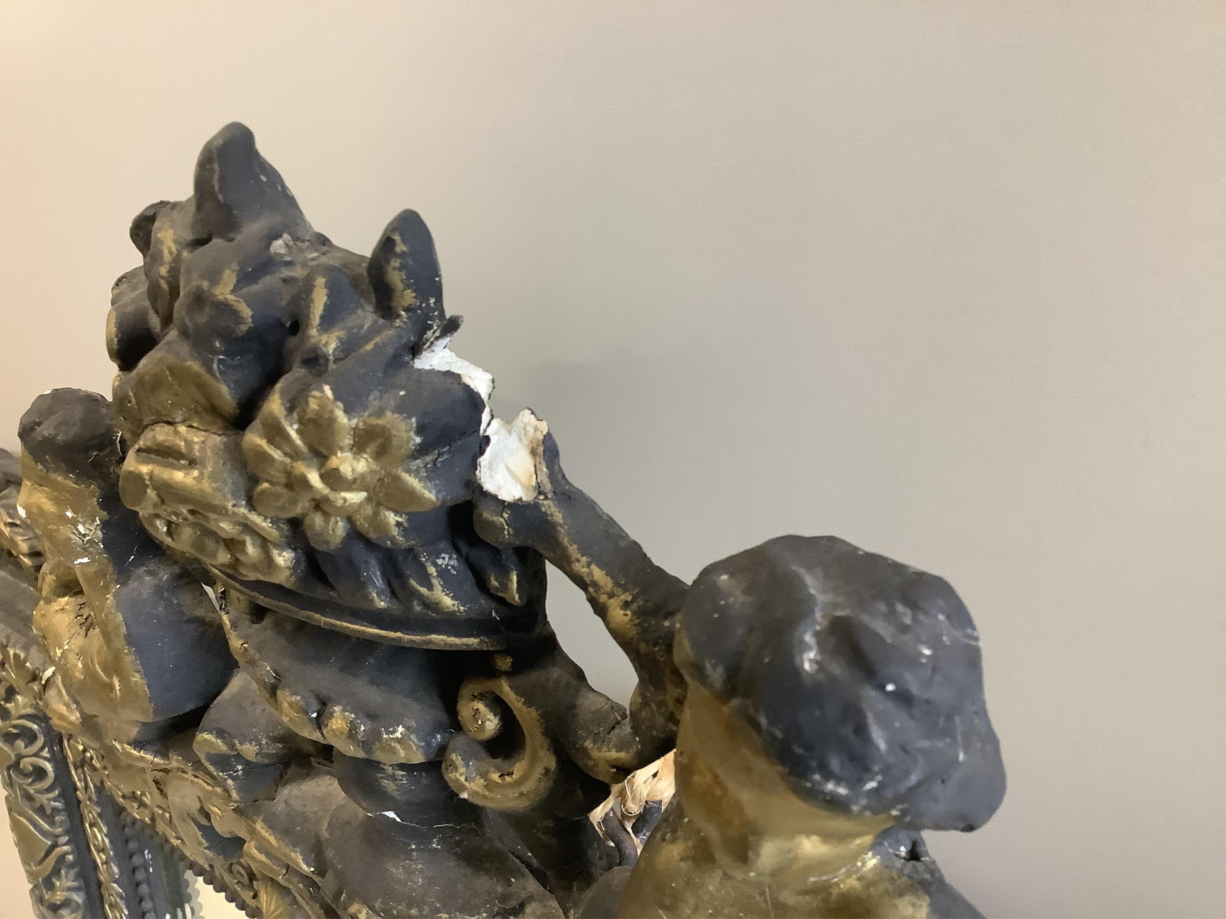 A French decorative wall mirror with cherub motifs, (later painted), width 81cm, height 127cm. Condition - poor
